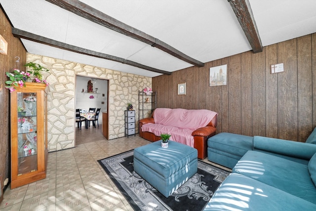 living room with light tile floors, wooden walls, and beam ceiling