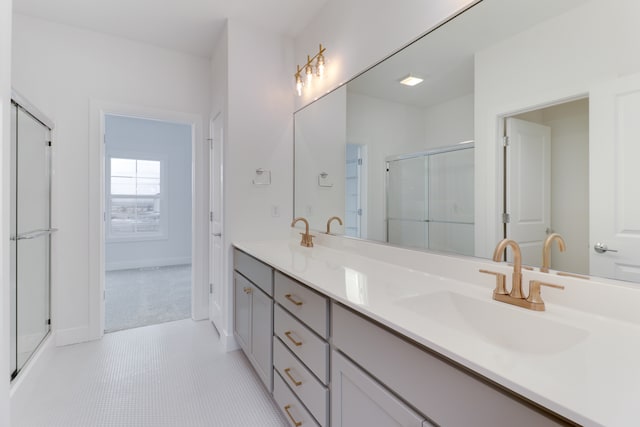 bathroom featuring oversized vanity, an enclosed shower, tile floors, and double sink