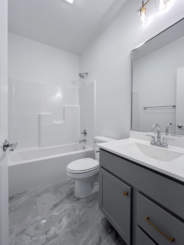 full bathroom with  shower combination, toilet, tile floors, and vanity with extensive cabinet space