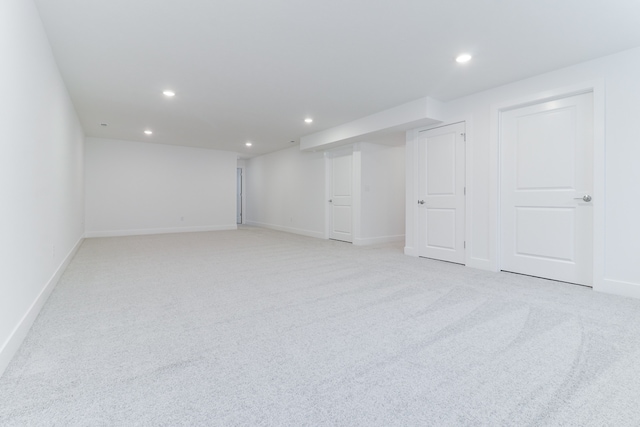 basement featuring light carpet