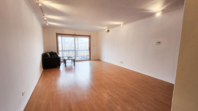 25A Kingery Quarter Unit 201, Willowbrook, IL 60527 - unfurnished living room featuring track lighting and light wood finished floors