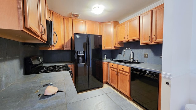 kitchen featuring sink, tasteful backsplash, and black appliances