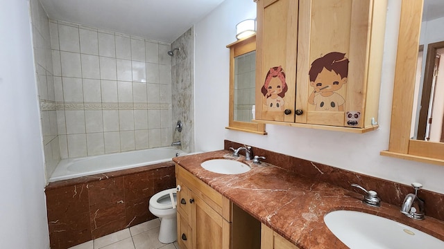 full bathroom featuring tile patterned flooring, vanity, toilet, and tiled shower / bath