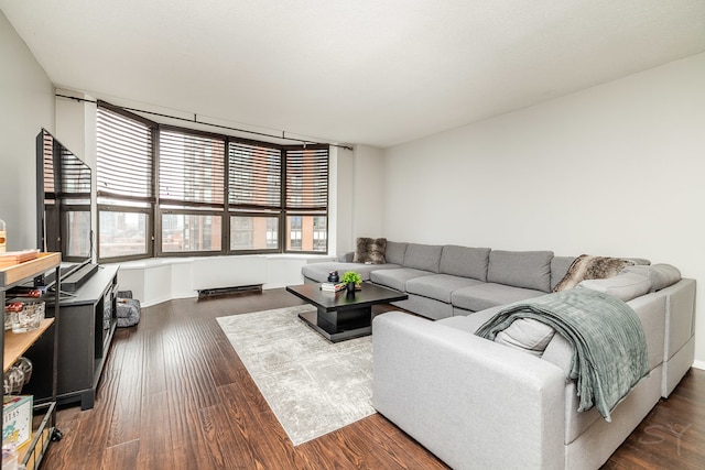 living room with plenty of natural light and dark wood-type flooring