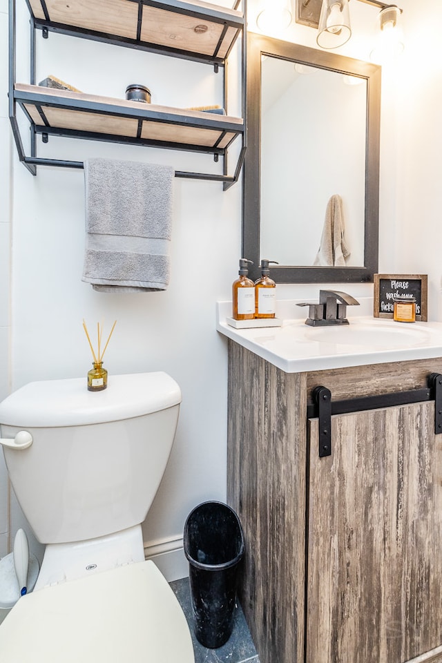 bathroom with toilet and vanity