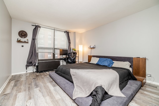 bedroom with light wood-type flooring