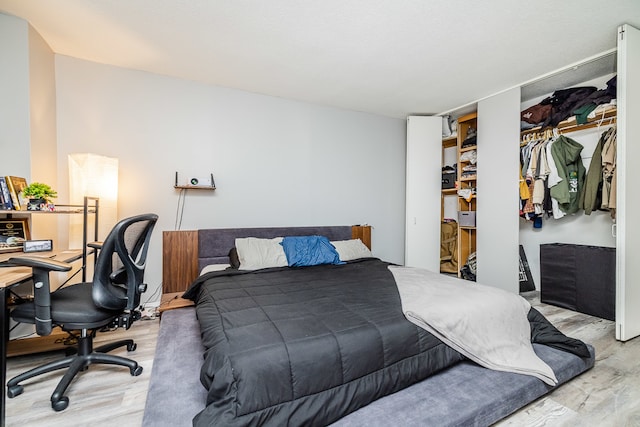 bedroom featuring a closet and light wood-type flooring