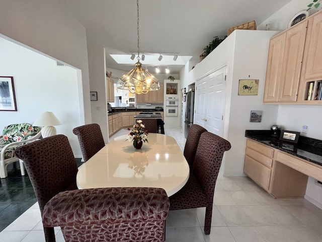 dining room with light tile patterned flooring and a notable chandelier