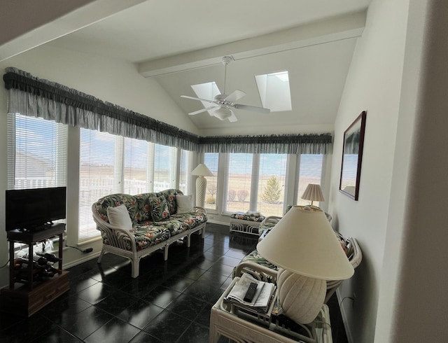 sunroom featuring beam ceiling and a skylight