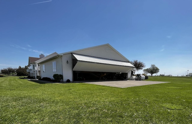 view of side of home with a yard