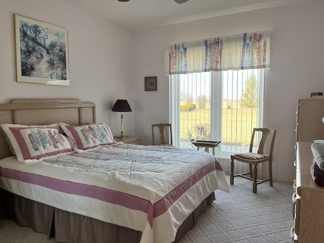 bedroom featuring light colored carpet and baseboards
