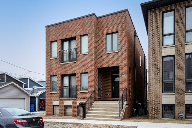 townhome / multi-family property featuring brick siding