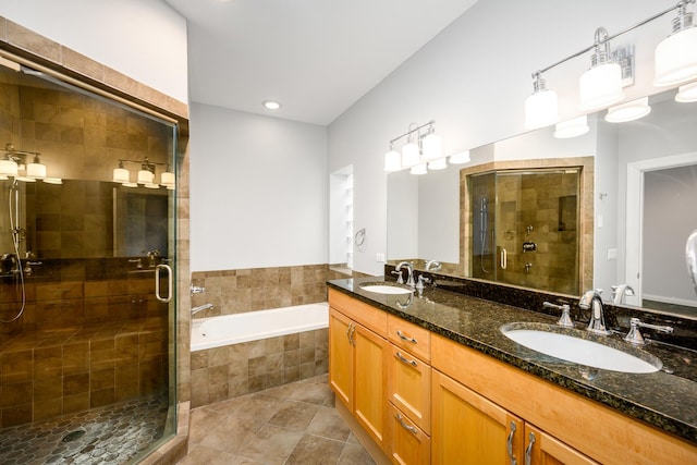 bathroom with a sink, a bath, and a shower stall