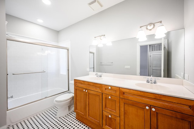 full bath featuring double vanity, combined bath / shower with glass door, a sink, and visible vents