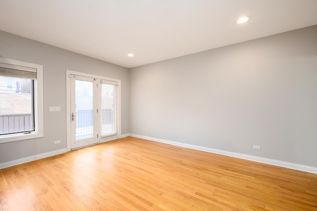 spare room with baseboards, recessed lighting, visible vents, and light wood-style floors