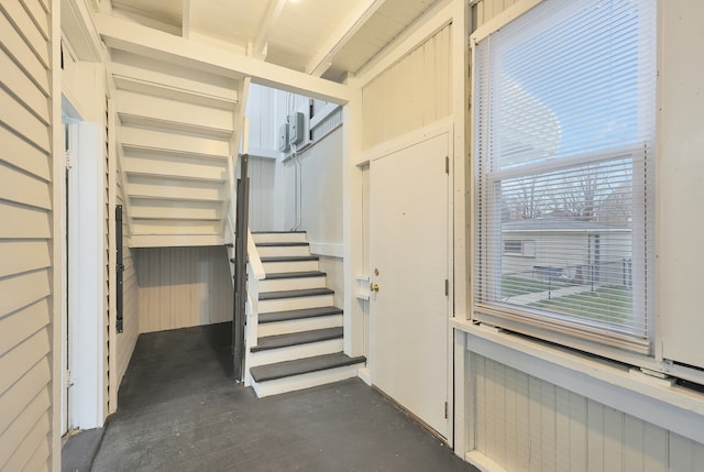 stairs with radiator and concrete flooring