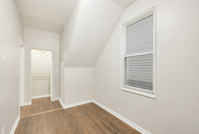 bonus room with dark hardwood / wood-style flooring and lofted ceiling