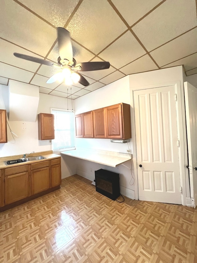 kitchen featuring light parquet flooring, ceiling fan, and sink