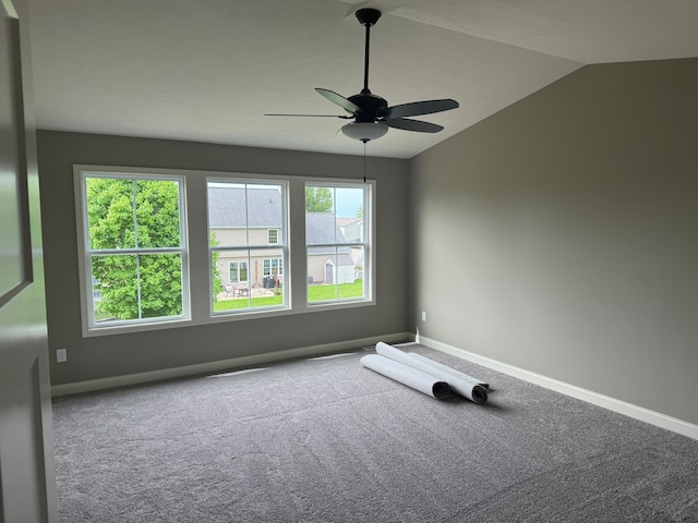 empty room with carpet flooring, ceiling fan, and vaulted ceiling