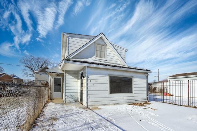 view of snow covered rear of property