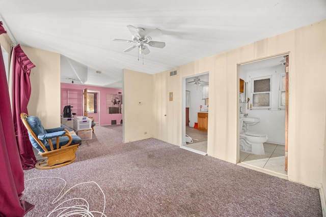 living area with light colored carpet and ceiling fan