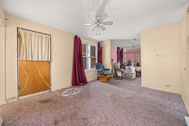 interior space featuring ceiling fan and carpet