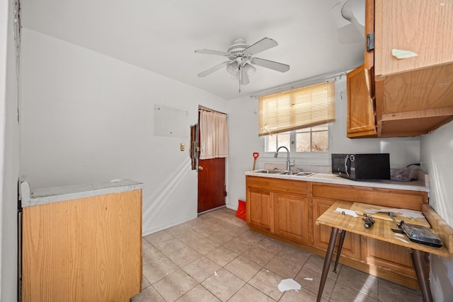 kitchen featuring sink, light tile patterned floors, and ceiling fan