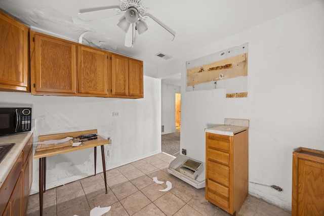 kitchen featuring light tile patterned floors and ceiling fan