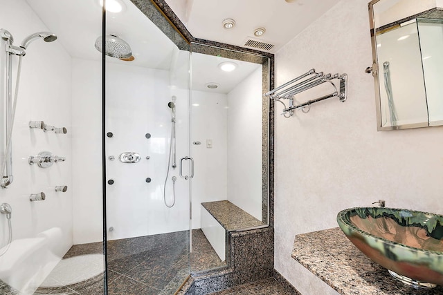 bathroom featuring walk in shower and sink