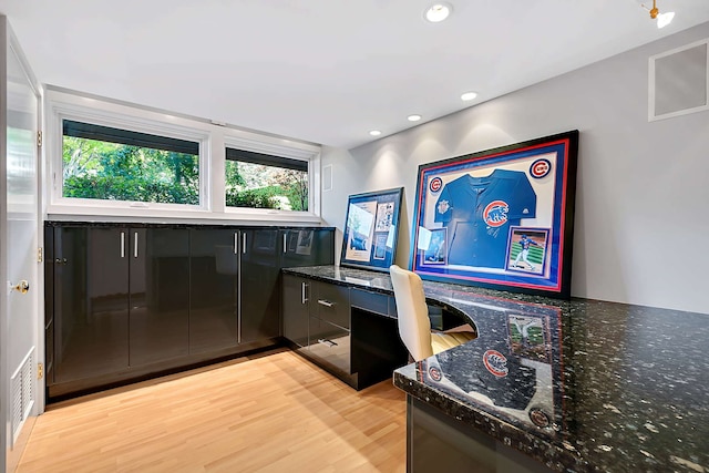 office area featuring built in desk and light hardwood / wood-style flooring