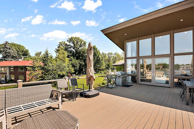 wooden terrace featuring area for grilling, french doors, and an outdoor hangout area