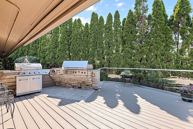 wooden deck featuring a grill and exterior kitchen