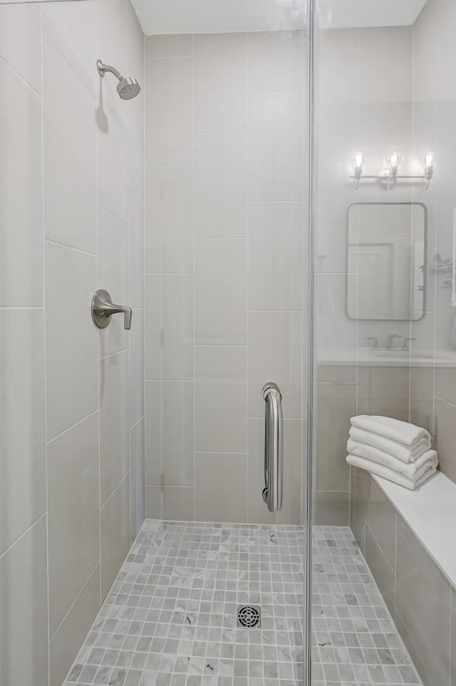 bathroom with a shower with door