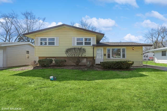 split level home featuring a front lawn