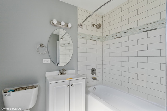 full bathroom with toilet, tiled shower / bath combo, and vanity