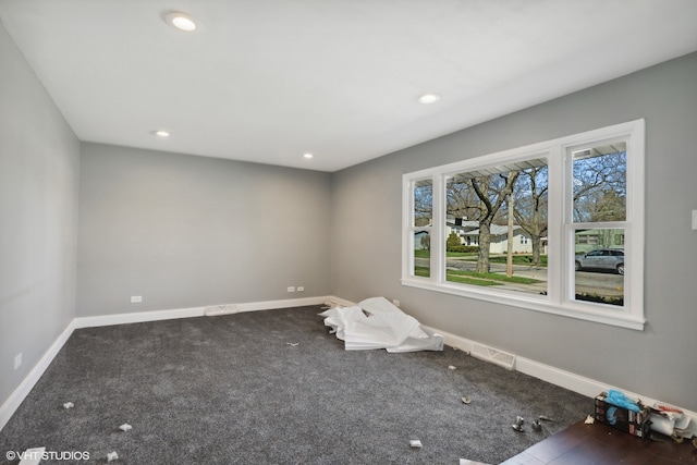 empty room with dark colored carpet