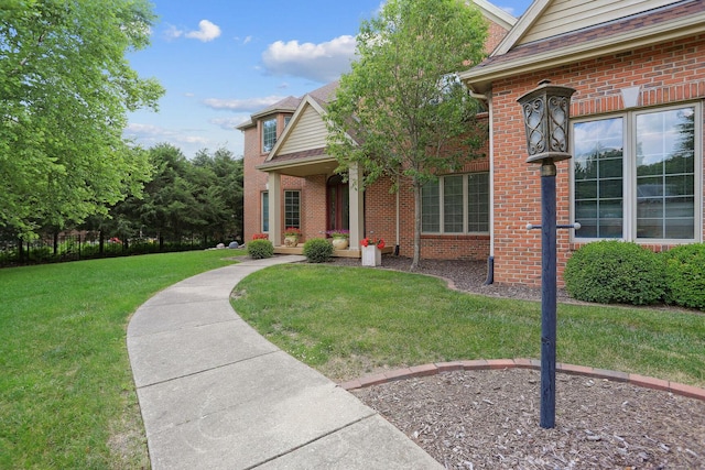 view of exterior entry with a lawn