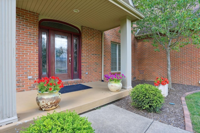 view of exterior entry featuring covered porch