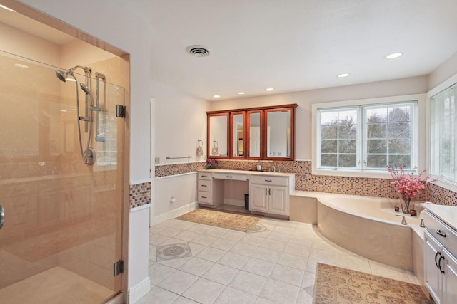 bathroom with tile patterned floors, vanity, and separate shower and tub