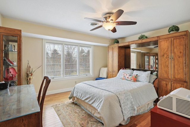 bedroom with ceiling fan and light wood-type flooring