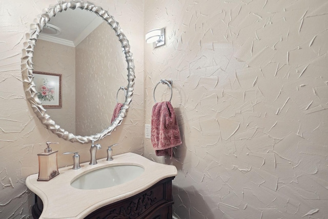 bathroom featuring crown molding and vanity