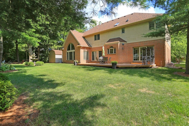 rear view of house with a wooden deck and a yard