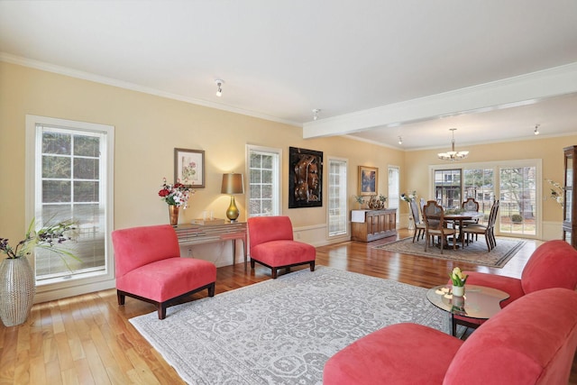 living room featuring crown molding, hardwood / wood-style flooring, and a chandelier