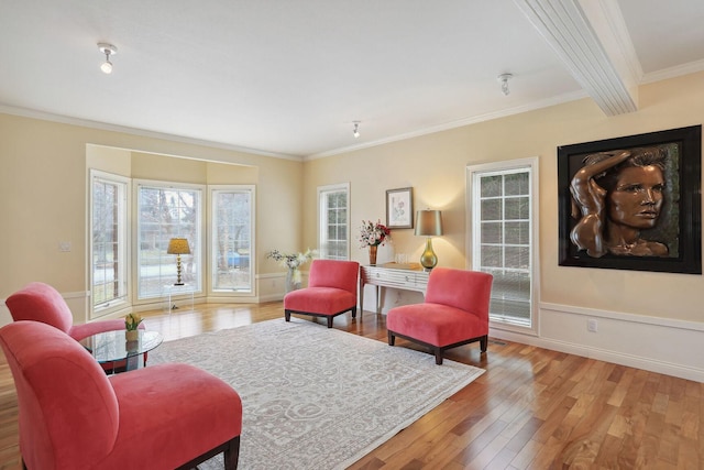 living area featuring ornamental molding and light hardwood / wood-style floors