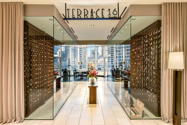 wine cellar with floor to ceiling windows and light tile flooring