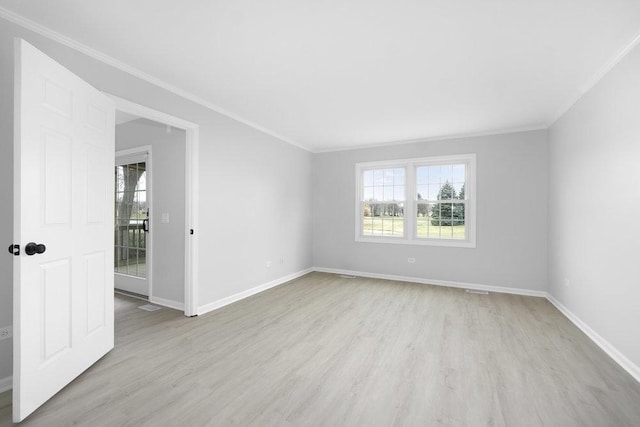 empty room featuring light hardwood / wood-style flooring and crown molding