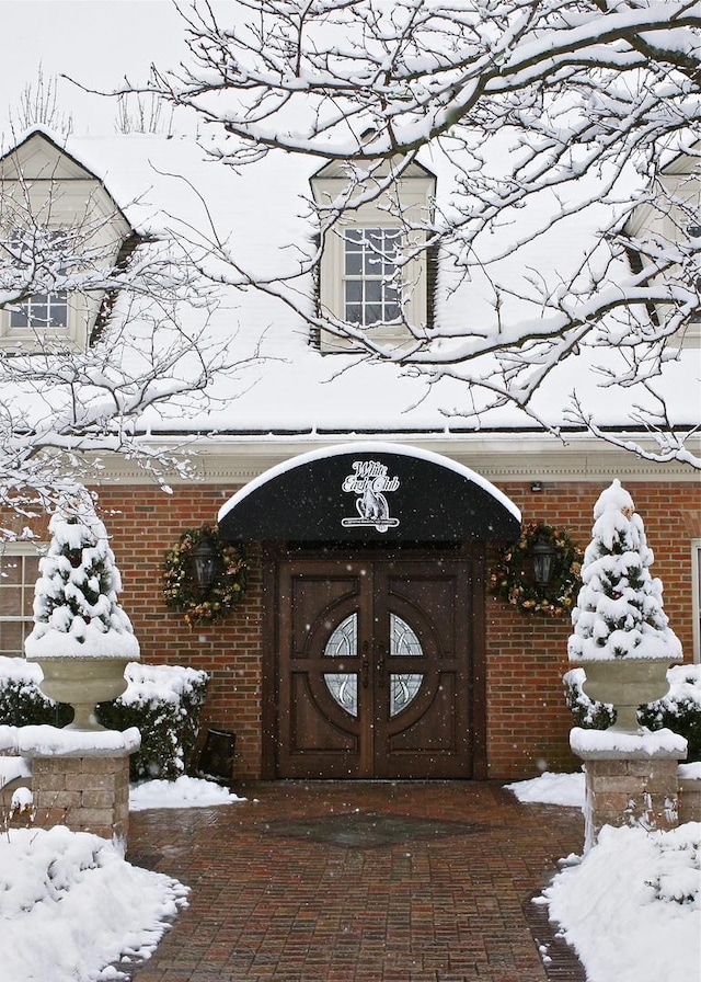 view of snow covered property entrance