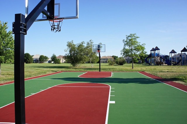 view of sport court featuring a playground and a lawn