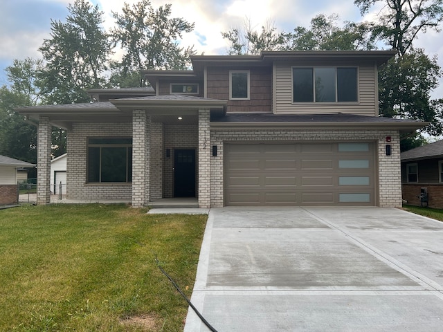 prairie-style home featuring a garage and a front lawn