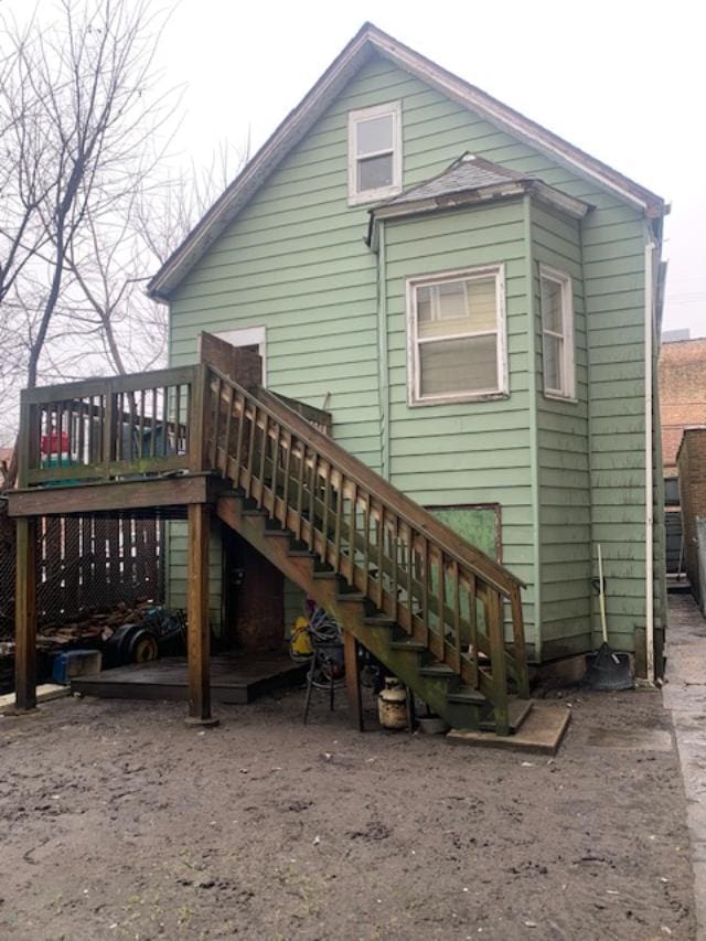 back of property with a wooden deck